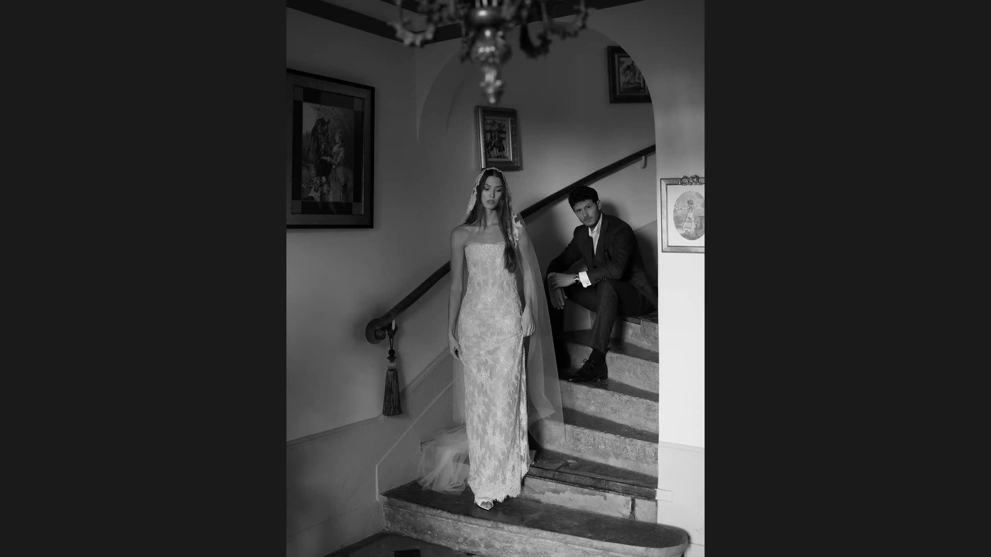 Black and white photo of a couple standing on a staircase