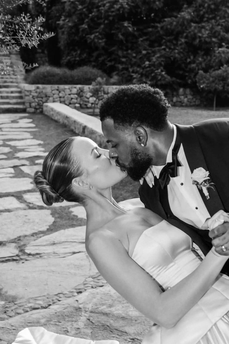 Black and white photo of a couple embracing outdoors.